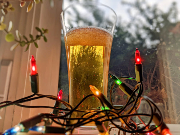 Skarey American Pilsner in a glass surrounded by twinkle lights.